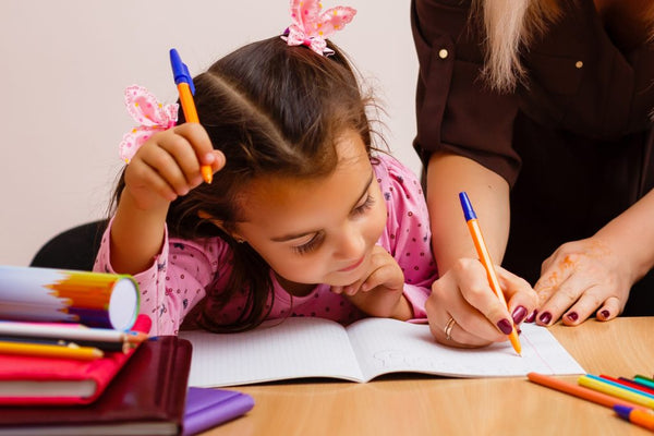 Child writing in a notebook