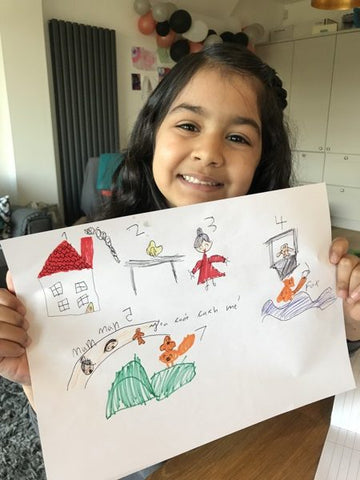 A child holding up home learning 6