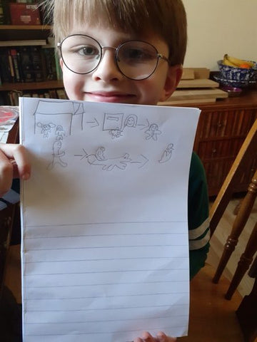 A child holding up home learning 7
