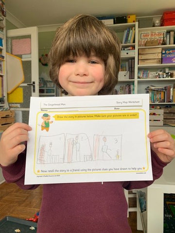 A child holding up home learning 11