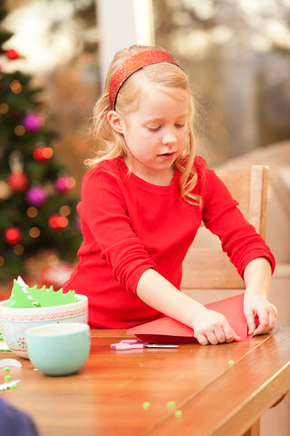 Child doing Christmas crafts