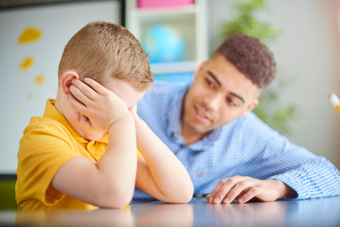 Teacher talking to an upset child