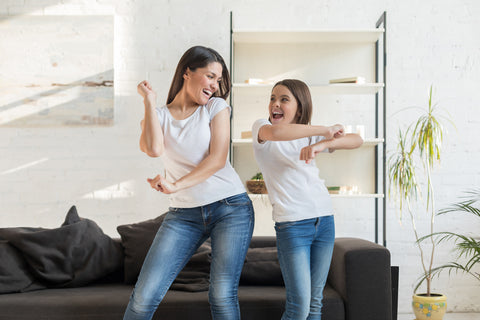 A mother and daughter practising their dance moves