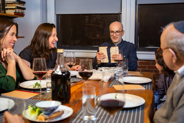 A family celebrating passover together and breaking the matzah