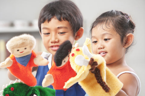 Children playing with puppets