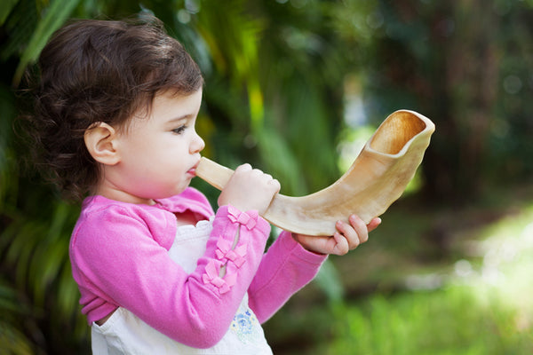 A child blowing the shofar