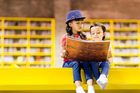 two children sharing a book