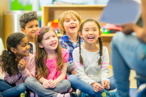 children enjoying listening to a story