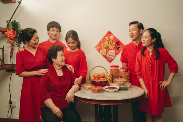 An Asian family dressed in red at Chinese New Year.