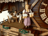 Waitress in Traditional Bavarian Dirndl carrying four Beer Mugs on Anton Schneider Chalet Cuckoo Clock