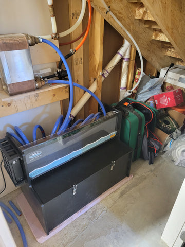 in the closet, next to the luggage sits the HUG Hydronics in-floor heating unit