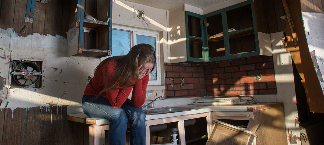 Woman crying after hurricane / fire