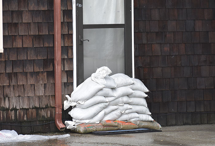 sandbags sitting in front of a door on a stormy day