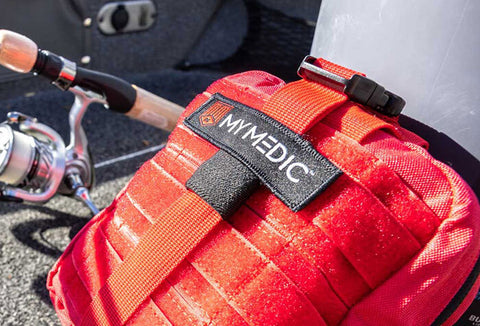 Red backpack filled with first aid supplies.