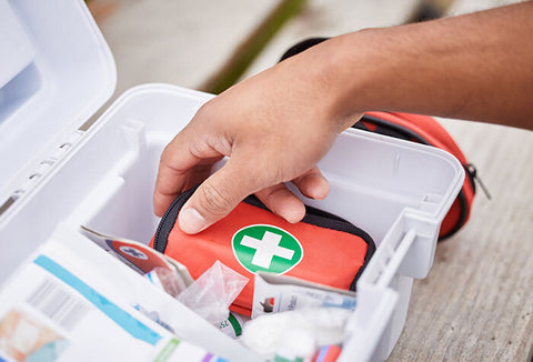 Person going through first aid kit. 