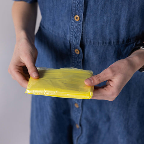 Girl holding folded poncho