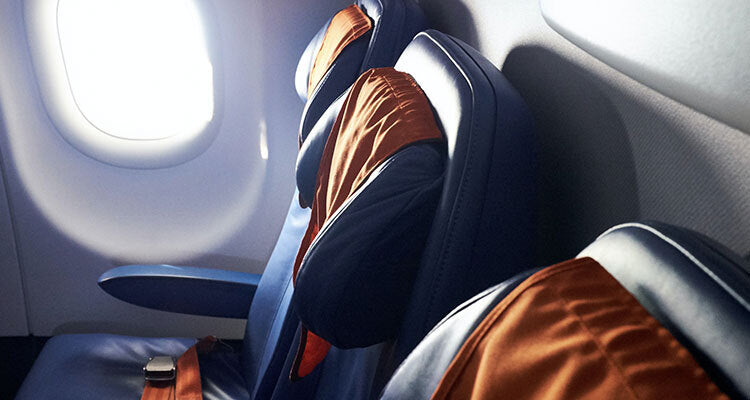 Empty airline seats with blankets draped over them