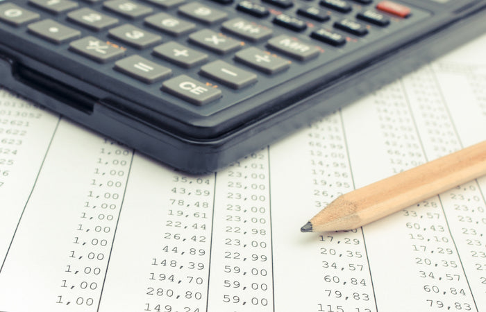 calculator and pencil on a table