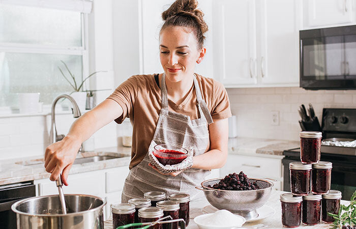 woman in a kitchen canning food