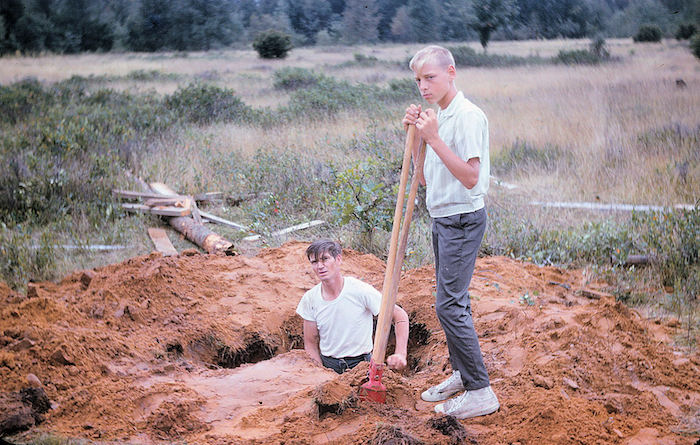 two men digging a well