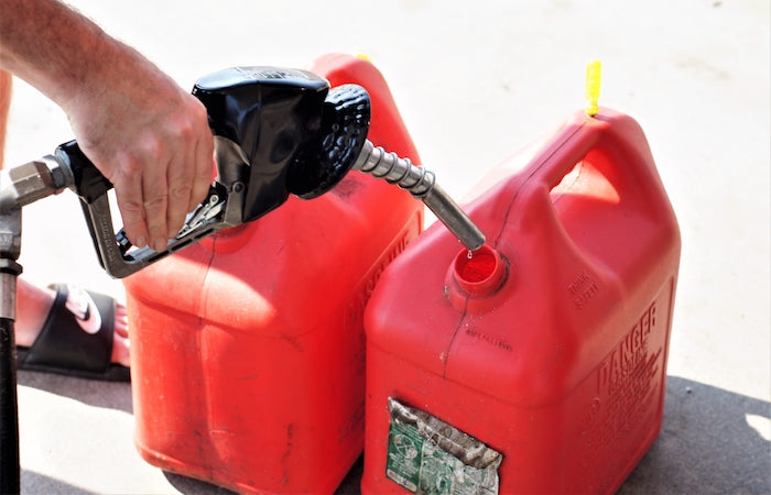 red gas cans being filled