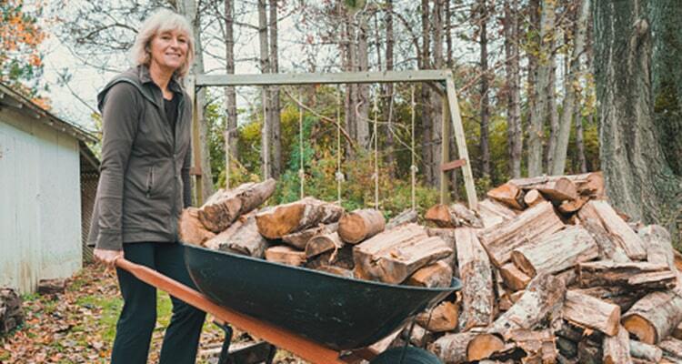 Woman with wood in a barrel