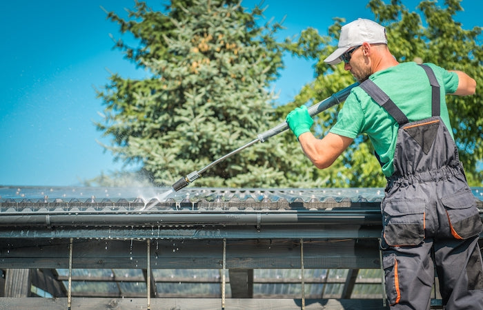 Man Cleaning Rain Gutters