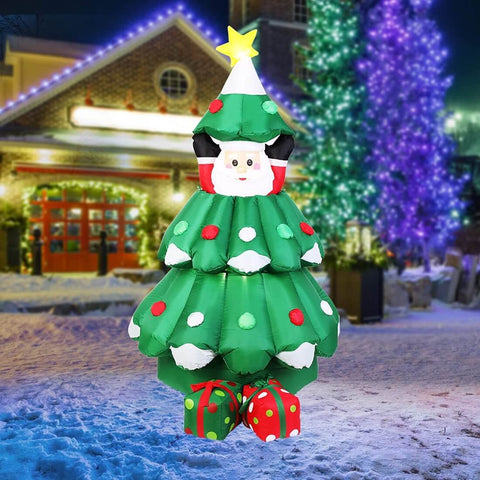 santa with lighted christmas tree