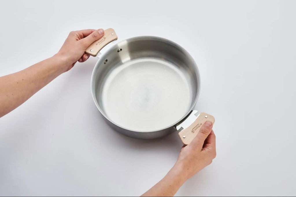 Person removing handles from pan