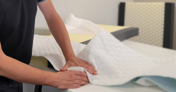 A close up of a baby mattress being tested for appropriate firmness