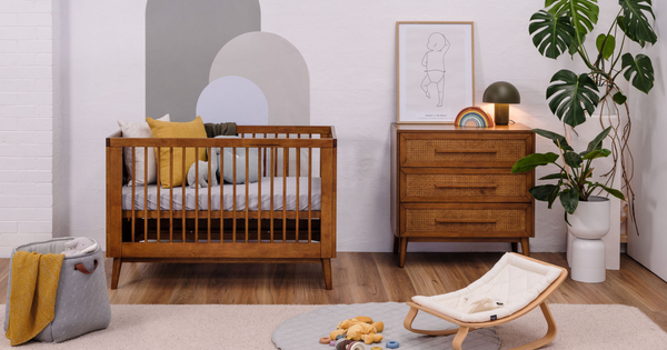 Babyrest Kaya cot and chest in teak, pictured in cosy nursery setting