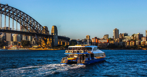 A ferry going past the harbour bridge in Sydney