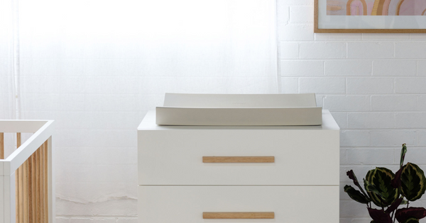 A grey Babyrest Nova sits on top of a Babyrest Torquay chest of drawers in a nursery