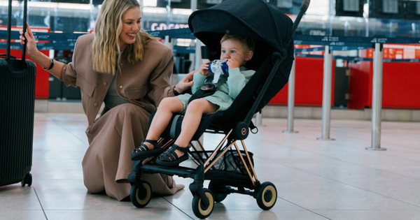 Mother and child using the Cybex Coya stroller in an airport