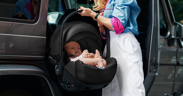 Mother transferring baby into car using a Cybex Cloud Q capsule