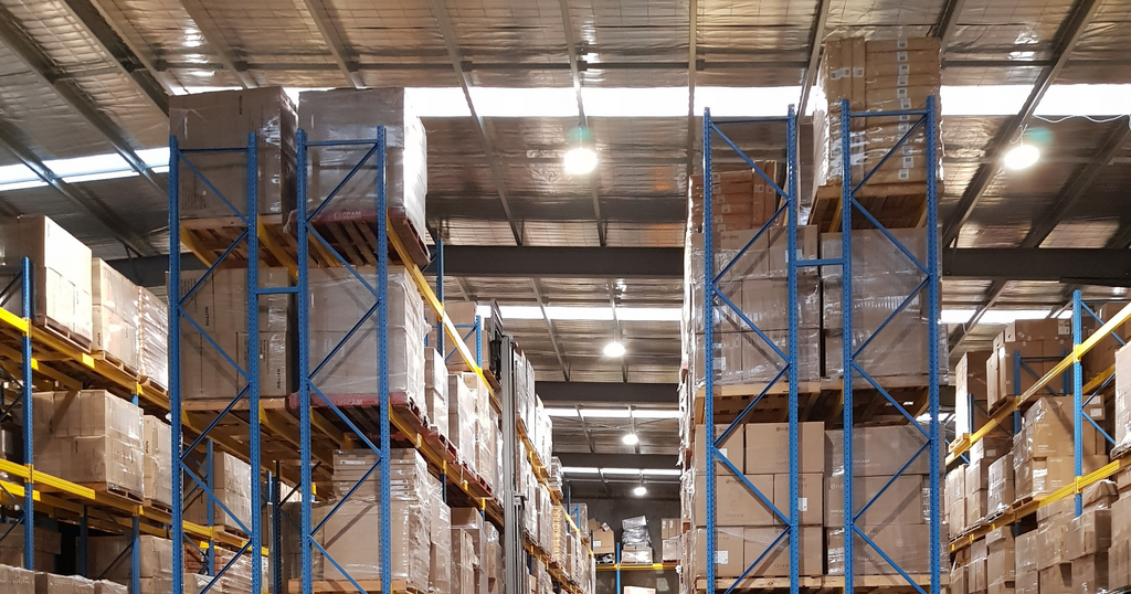 Tall shelves filled with boxed products inside the Anstel warehouse