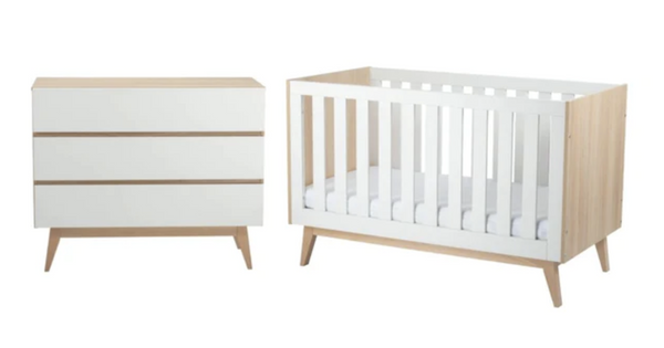 The Babyrest Tommi cot and chest stand side by side. They have angled, tapered legs and the white and oak colours complement one another for a neutral design