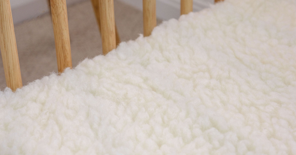 Close up of the wool texture of the Babyrest wool underlay on a cot mattress