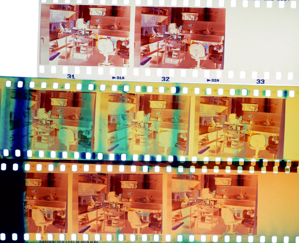 Photo of CineStill 800T (top) and imitation films processed together, on a light table (white balanced to a normal color negative dye mask).