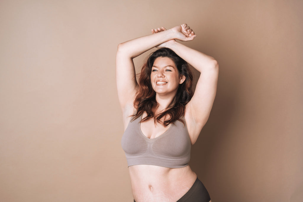 smiling plus size woman wearing bra