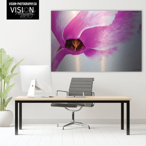Large statement piece of photographic art behind a desk in an office featuring a pink cyclamen created by Laura Cook of Vision Photography