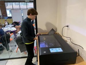 Students using FLUX laser cutter