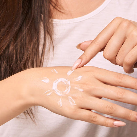 sunscreen on woman's hand