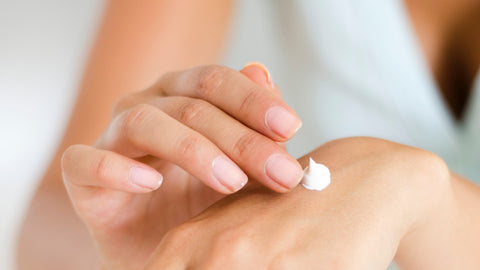 white-woman-applying-cream-to-hand-linda-prebreza-pexels