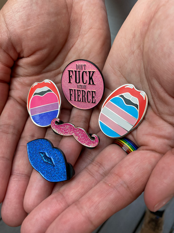 Custom Pride Pins from Queen On The Scene in Enamel Bisexual Pride Pins, Trans Pride Pins and Glitter Pride Pins, Hot Pink Enamel Pins, Round Enamel Pins and More.
