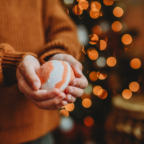 A child holding homemade bath bomb to leave for Santa gift.