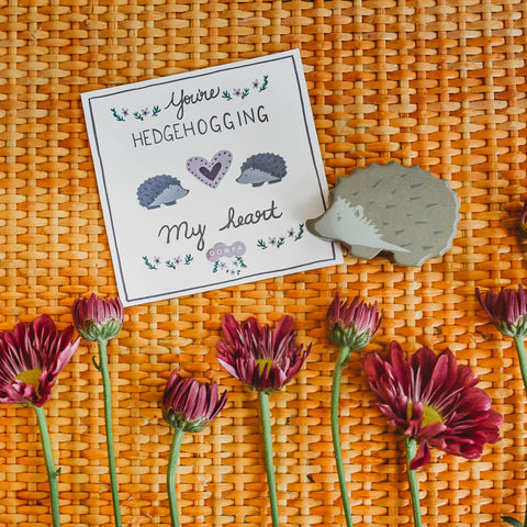 Flowers and a Tenderleaf Toys hedgehog next to a printable Valentine's Day card.