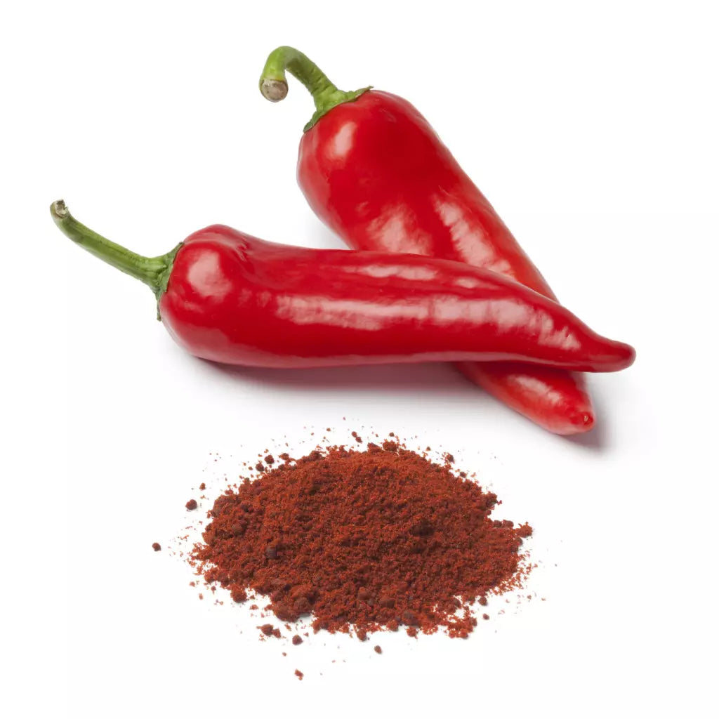 Two red chili peppers and a pile of red chili powder.