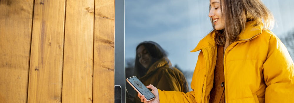 Woman using phone to unlock smart lock