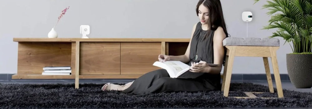 Woman relaxing in lounge room with Sensibo air conditioning products